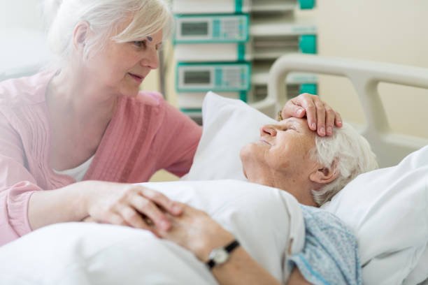 Daughter visiting her senior mother in hospital