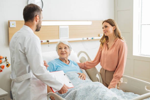 Woman visiting her mother at hospital, she is talking with doctor and showing love and care for her mother.